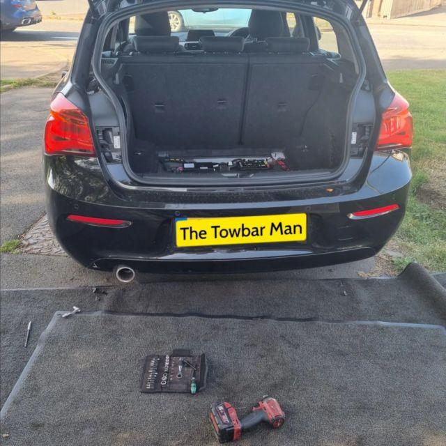 Professional towbar installation engineer at work