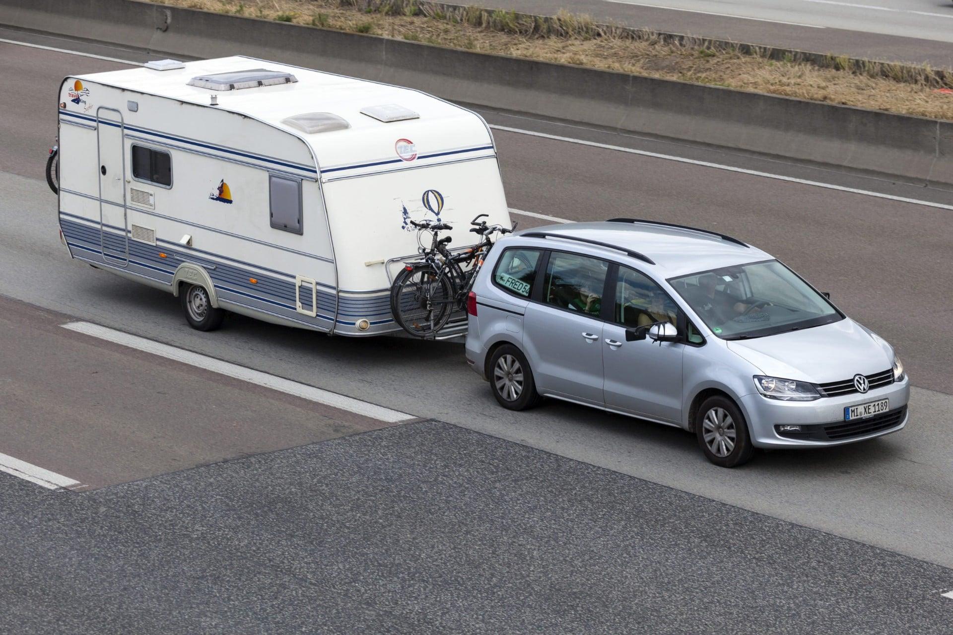 Grey Volkswagan towing Caravan